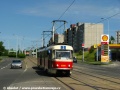 Křižovatkou u zastávky Sídliště Hloubětín, ještě neopatřenou světelnou signalizací, burácí na velkoplošných panelech BKV souprava vozů T3M ev.č.8006+8097 vypravená na linku 3. | 14.6.2009