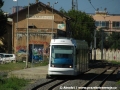 Vůz č. CA 04 projíždí ve směru z centra kolem opuštěné výpravní budovy někdejšího nádraží Monserrato - Pirri před tramvajovou zastávkou Caracalla. Betonové nástupiště na snímku se již nepoužívá. | 27.7.2010