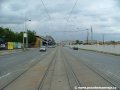 Tramvajová trať tvořená velkoplošnými panely BKV pokračuje středem ulice Milady Horákové k zastávkám Sparta