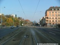 Středem Plzeňské ulice na zvýšeném tělese pokračuje tramvajová trať v klesání, přibližuje se ke světelně řízené křižovatce