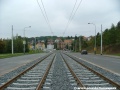 Tramvajová trať v klesání ve středu Makovského ulice pokračuje otevřeným svrškem tvořeným kolejnice S49