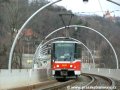 Souprava vozů T6A5 ev.č.8601+8602 vypravená na linku 12 stoupá po mostě přes Hlubočepskou ulici k zastávce Geologická | 1.4.2006