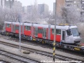 Lokomotiva 740.469-2 posunuje vůz Škoda 14T ev.č.9115 ložený na třech plošinových vozech k rampě předávací koleje Zličín | 28.12.2006