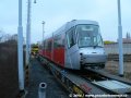 Na třech plošinových vozech ložený vůz Škoda 14T ev.č.9119 na nádraží Praha-Zličín u rampy předávací koleje. | 16.2.2007